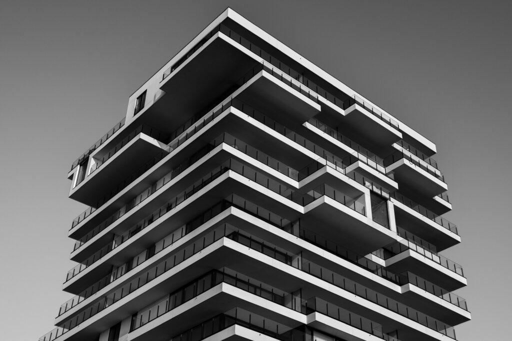 pexels-photo-157811-157811 A striking black and white photo of a modern high-rise building with unique geometric designs.